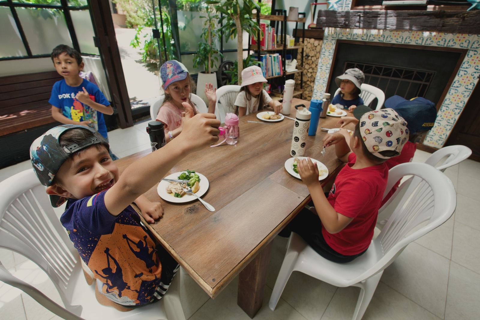 Un niño levanta el pulgar mientras almuerza con sus compañeros